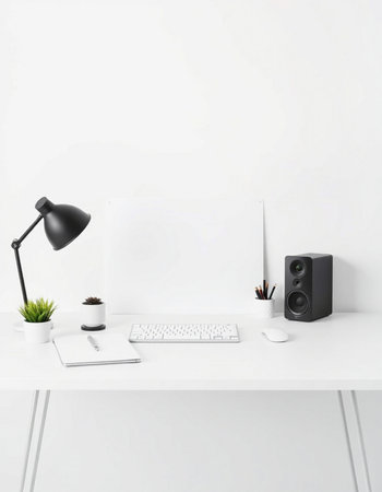 Modern workplace with computer, supplies and coffee cup on white wall backgroundの写真素材