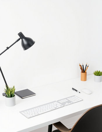 Front view of modern designer workplace with blank white wall, computer keyboard, stationery and plant. Mock upの写真素材