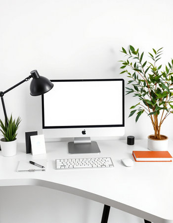 Modern workplace with computer, keyboard, mouse, stationery and plant.の写真素材