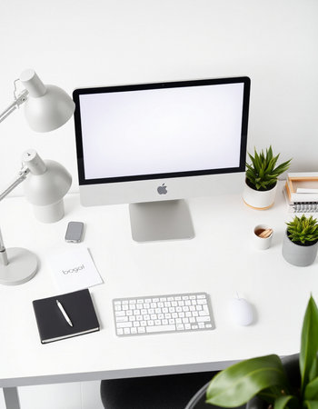 Workplace with blank screen computer, keyboard, stationery and decorationsの写真素材