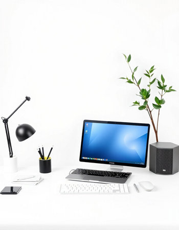 Modern workspace with computer, keyboard, mouse, mouse, smart phone and plant.