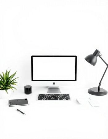 Modern workspace with blank screen computer, coffee cup, stationery and plant on white background