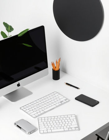 Workplace with computer, mobile phone and stationery on white table