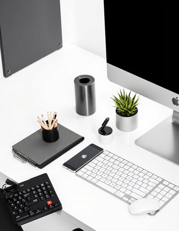 Modern workspace with computer, keyboard, mouse, coffee cup and other office supplies