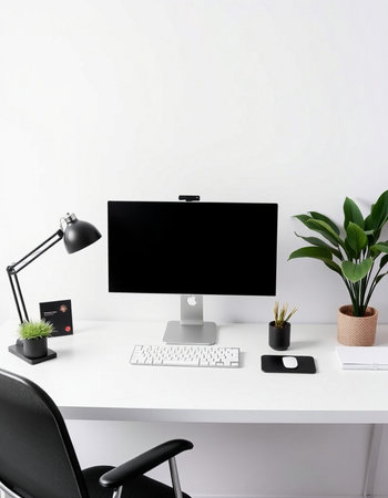 Modern workspace with blank screen computer, keyboard, mouse and office supplies on white table