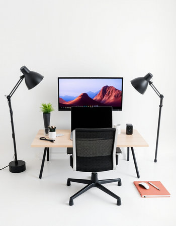 workplace with computer, chair and lamp on the white wall backgroundの写真素材