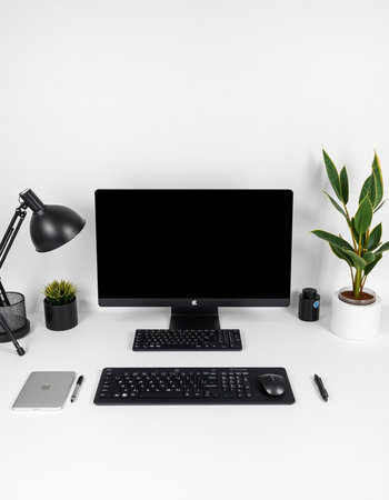 Modern office desk with computer, keyboard, mouse, lamp and plant