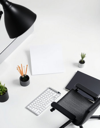 White office desk with blank paper, computer keyboard, potted plant and copy space
