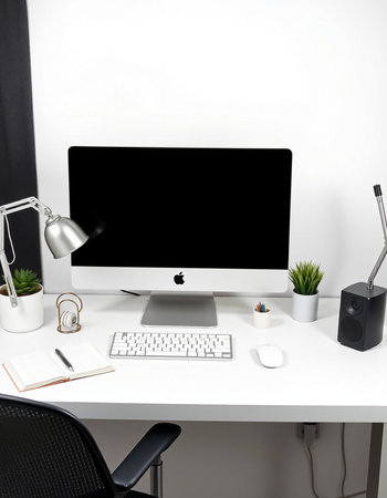 workplace with computer, keyboard, mouse and stationery on tableの写真素材