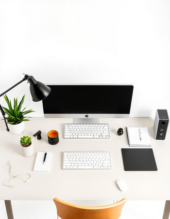 Modern workspace with computer, supplies and coffee cup on white background.の写真素材