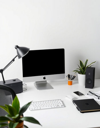 workplace with computer, lamp, stationery and plant on white backgroundの写真素材