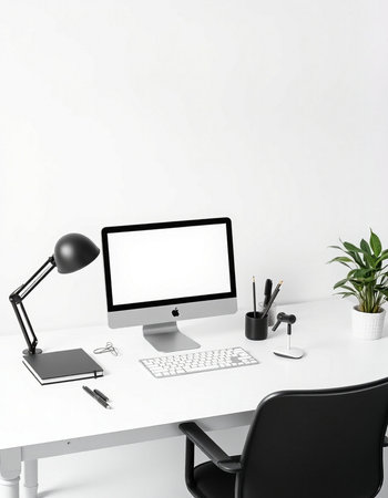 workplace with computer, lamp, keyboard, stationery and plant