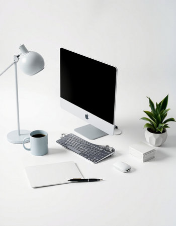 Office desk with computer, coffee cup, notebook and lamp on white backgroundの写真素材