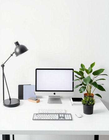 Front view of modern workspace with blank computer screen, keyboard, stationery and potted plant....