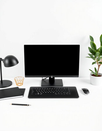 Modern workspace with black computer, keyboard, mouse, stationery and plant on white background