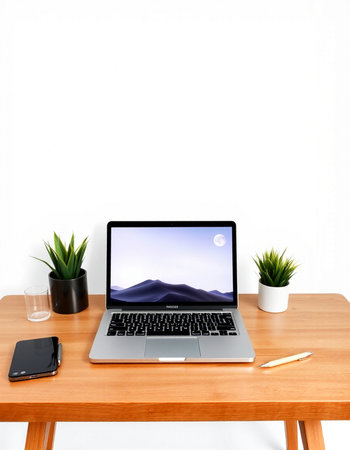 Laptop with blank screen on wooden table and white wall background.