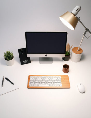 Office desk with computer, keyboard, mouse and other objects