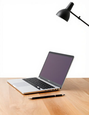 Laptop on the desk with pen and lamp isolated on white background