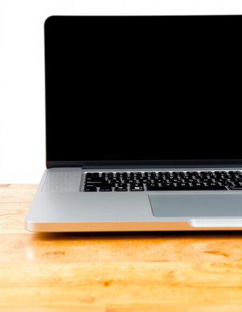 Laptop with blank screen on wooden desk, isolated on white background