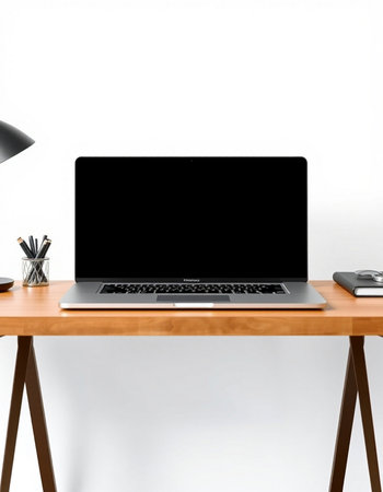 Laptop with blank screen on wooden table isolated on white wall background