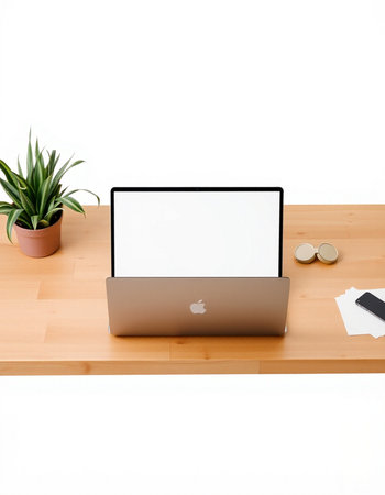 Modern workspace with blank screen laptop on wooden desk.