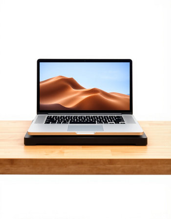 Laptop on wooden desk with sand dunes isolated on white background