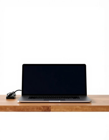 Laptop and mouse on a wooden table isolated on a white background