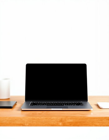 Laptop with blank screen on wooden desk with coffee cup on white background