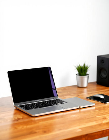 Laptop with blank screen on wooden table and white wall background.の写真素材