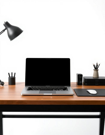 Modern workspace with blank screen laptop computer, stationery and office supplies on wooden desk.