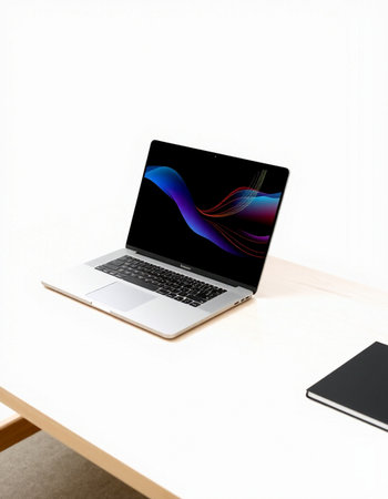 Laptop on the table with white wall background and copy space.