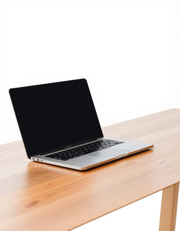Laptop on wooden table isolated on white background with clipping path.