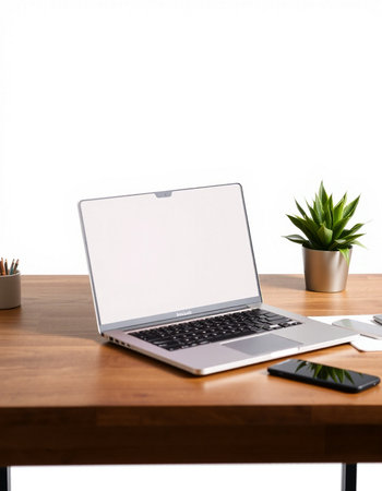 Modern workspace with blank screen laptop, coffee cup and other items on wooden table. Mock upの写真素材
