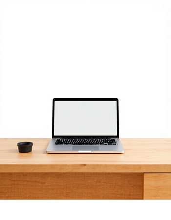 Laptop computer with blank screen on wooden table isolated on white background