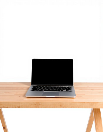 Laptop with blank screen on wooden table isolated on white background.