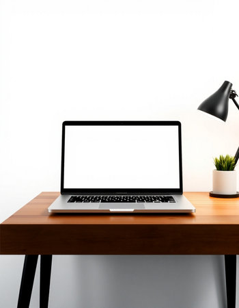 Laptop with blank screen on wooden desk and lamp on white wall background