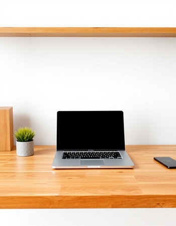 Laptop computer on wooden table and white wall background with copy spaceの写真素材