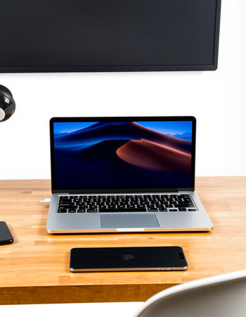 Laptop on wooden table in office