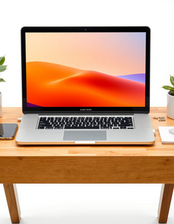 Modern workspace with laptop on wooden table isolated on white background.