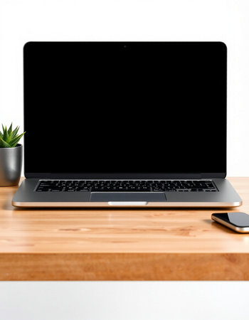 Laptop with blank screen on wood table and white wall background.