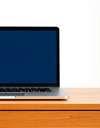 Laptop on wooden desk isolated on white background. Copy space.