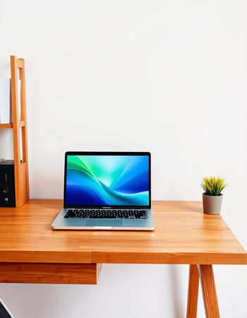 Laptop on a wooden table in a room with a white wall