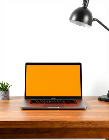 Laptop on wooden table and lamp on white background