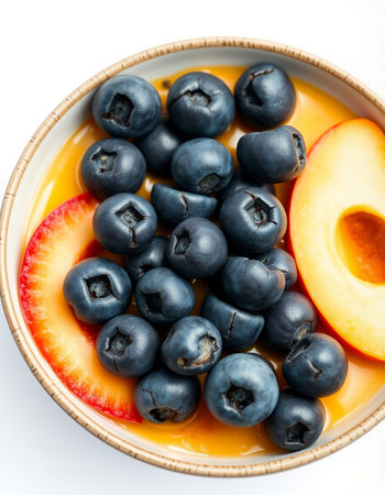 Close up of a bowl of fresh blueberries and apricots on white backgroundの写真素材