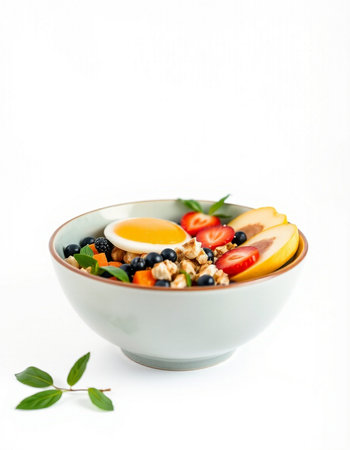 Healthy breakfast bowl with muesli, berries and eggs on white background