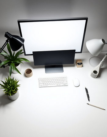 Modern workplace with computer, keyboard, mouse, lamp and other items.の写真素材