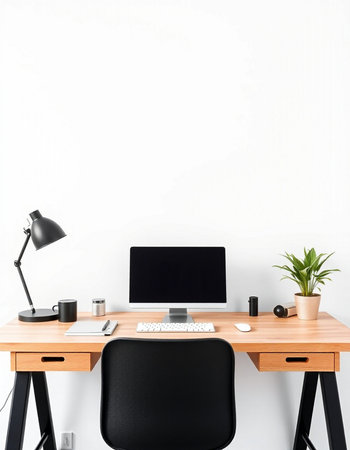 Front view of modern workplace with blank white wall, computer, coffee cup and other items. Mock up