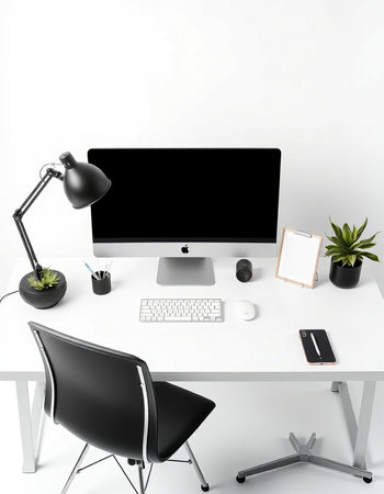 Workplace with computer, keyboard, mouse, lamp and plant.