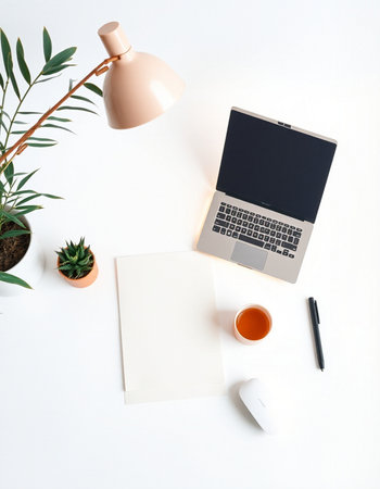 Flat lay, top view office workspace with laptop, coffee cup, plant and copy space on white...