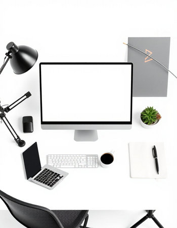 Top view of modern workplace with computer, supplies and coffee cup on white background. Workplace conceptの写真素材